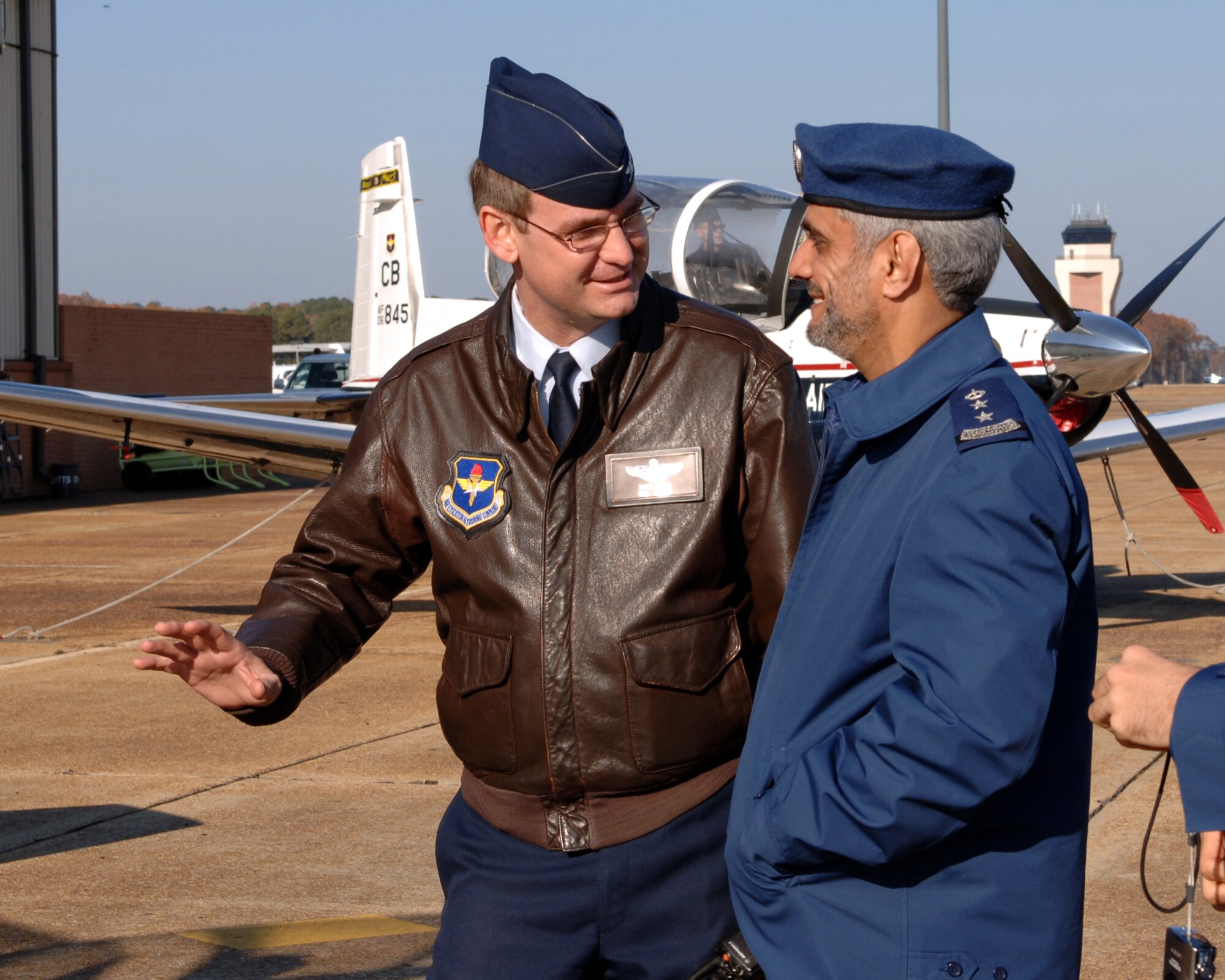 Colonel David Reth, 14th Operations Group commander, speaks with Col. Sulaiman Abdulrahman Alwabel, Flying Wing commander at King Faisal Air Academy, Saudi Arabia, at a static display of a T-6 Texan during a tour of Columbus AFB Tuesday. (U.S. Air Force photo by Elizabeth Owens) 