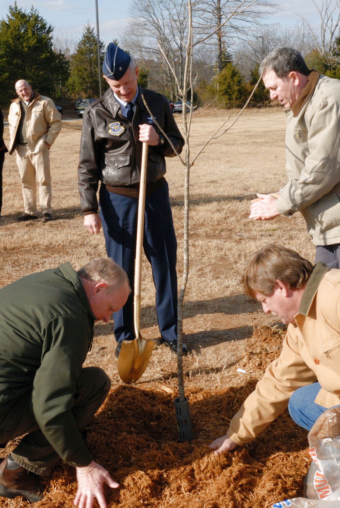 Brig. Gen. Rowayne A. Schatz Jr., Larry Nance, Pete Rausch and James Popham plant a tree for the 15th Annual Arbor Day ceremony Dec. 1 at the base child development center at Little Rock Air Force Base, Ark. General Schatz is the 19th Airlift Wing commander, Mr. Nance is the Arkansas deputy state forester, Mr. Rausch is from Tree Health Care, and Mr. Popham is the 19th Civil Engineering Squadron natural resources manager. (U.S. Air Force photo/Senior Airman Christine Clark) 