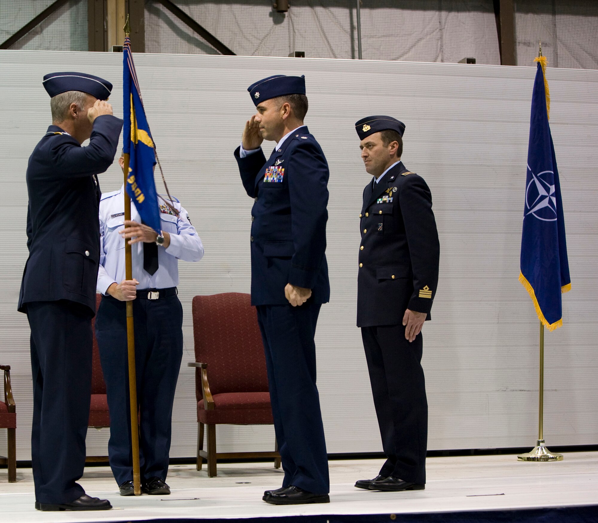 Lt. Col. Patrick Testerman, center, accepts command of the 89th Flying Training Squadron Dec. 1 from Col. Axel Pohlmann, 80th Operations Group commander, during a change of command ceremony. Italian air force Lt. Col. Vittorio Cencini, right, relinquished command. (U.S. Air Force photo/Lt. Col. Ternell Washington)