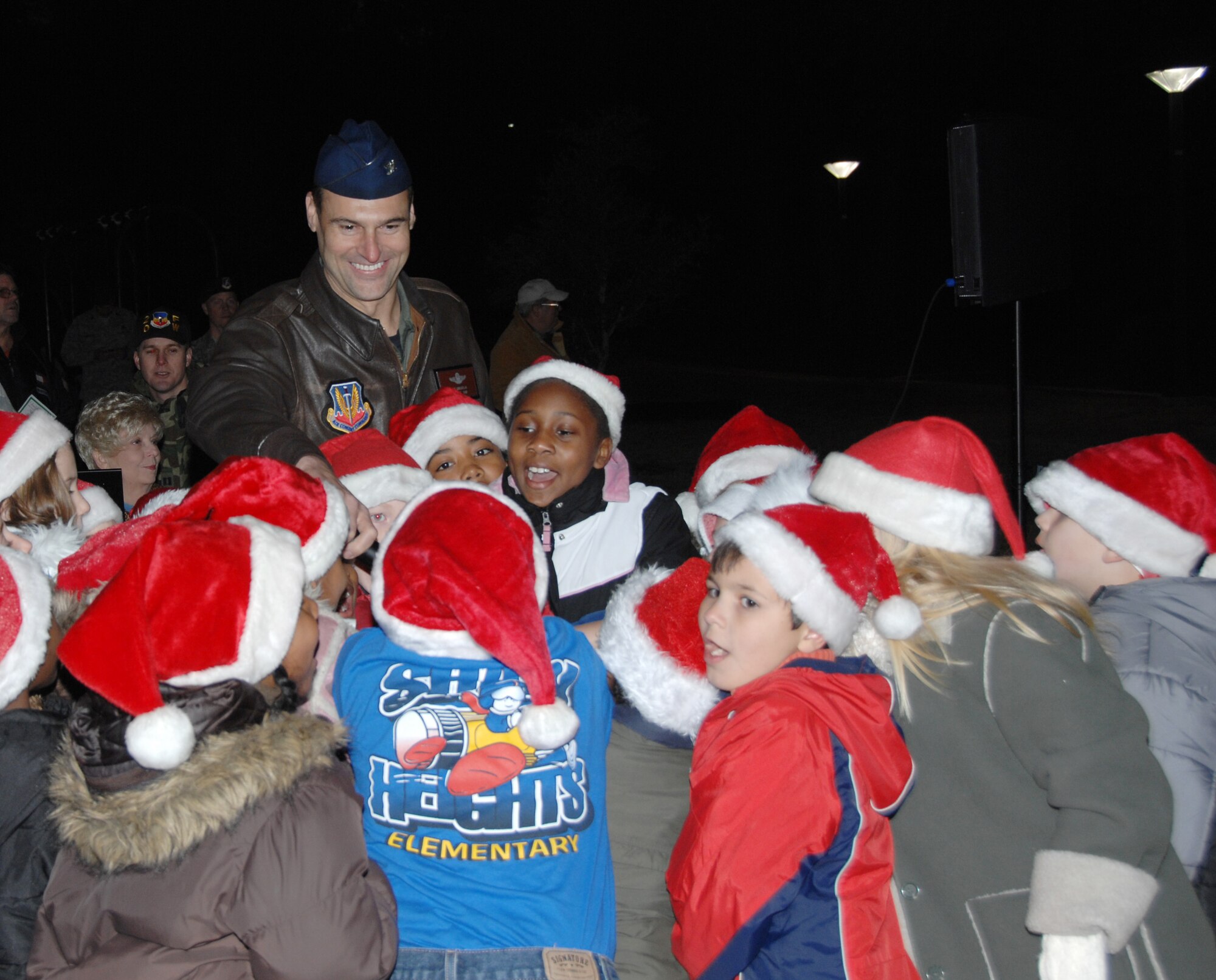 SHAW AIR FORCE BASE, S.C. -- Col. Joseph Guastella, 20th Fighter Wing commander, along with the help of the Shaw Heights Elementary School choir countdown and flip the switch to light Shaw's Christmas tree Dec. 2. The Shaw AFB Christmas Tree Lighting Ceremony is an annual event held at Memorial Lake. (U.S. Air Force photo/2nd Lt. Emily Chilson)