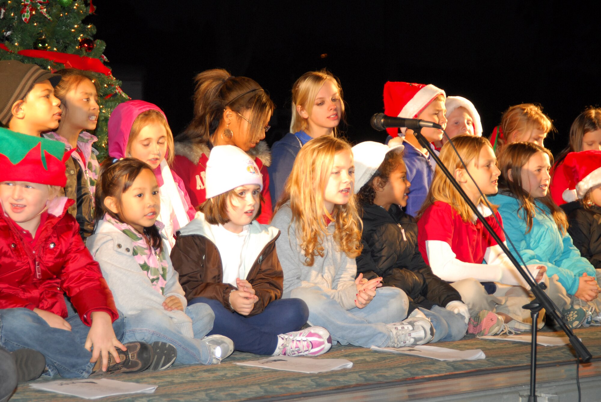 Tyndall Air Force Base children sing Christmas carols yesterday during the base Christmas tree lighting here.  The event was full of songs, lights, beverages, holiday cheer and a special appearance by Santa Claus himself.  (U.S. Air Force photo by Lisa Norman)