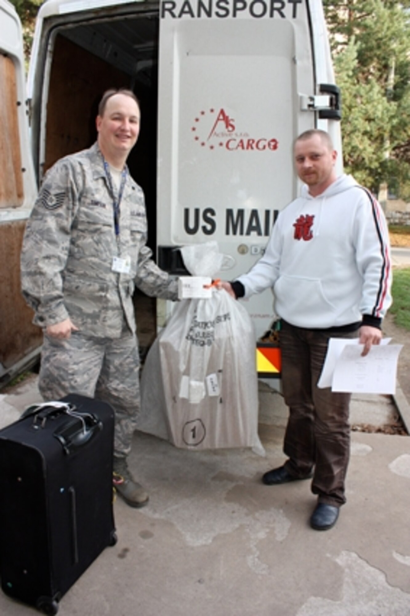 Postal Specialist TSgt Jason Simpson (TDY from Ramstein) receiving first Heavy Airlift Wing mail shipment from German contract driver.