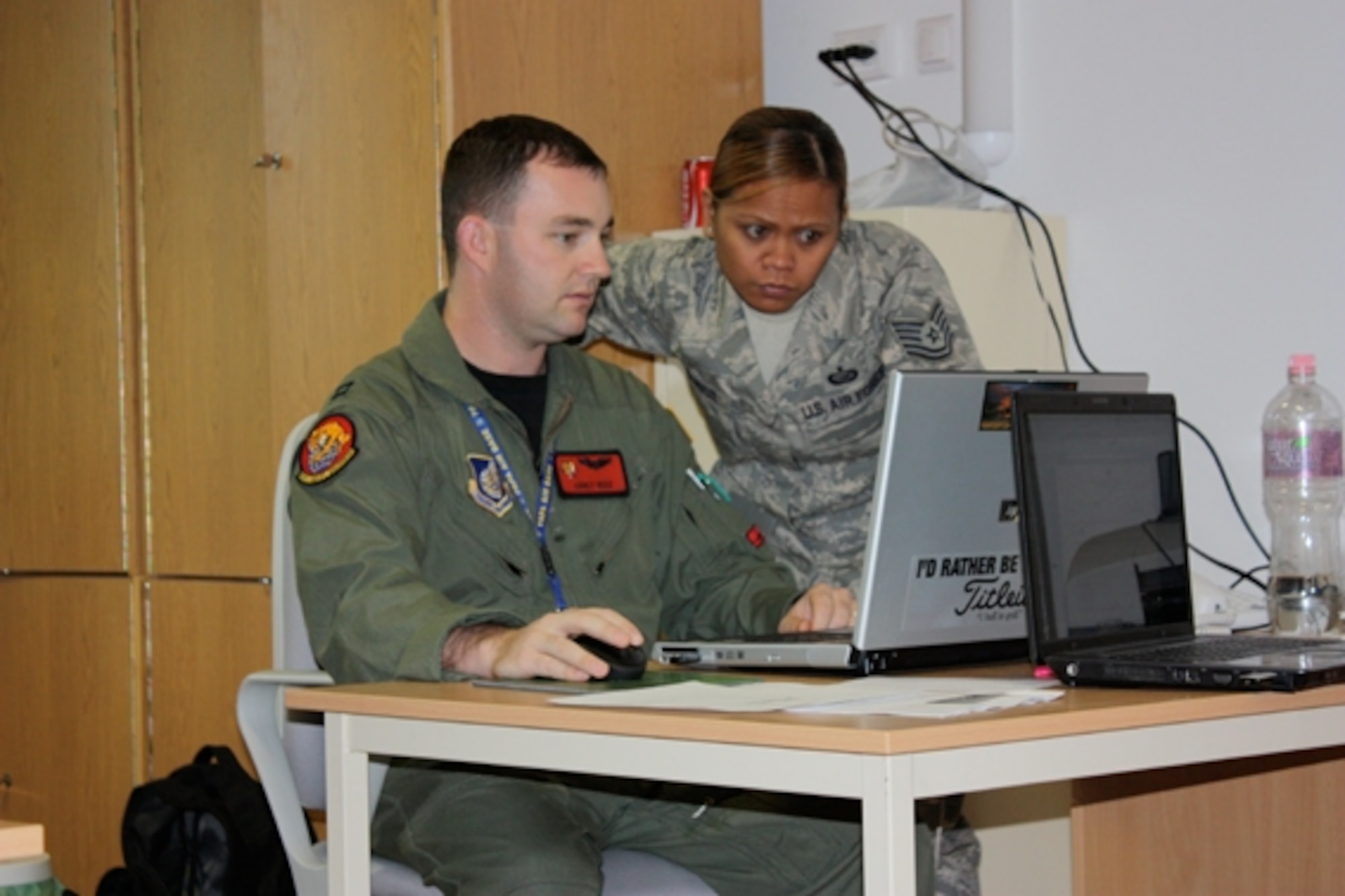 Capt Corey Reed and TSgt Ruby Corpuz completing required paperwork to properly account for mail.