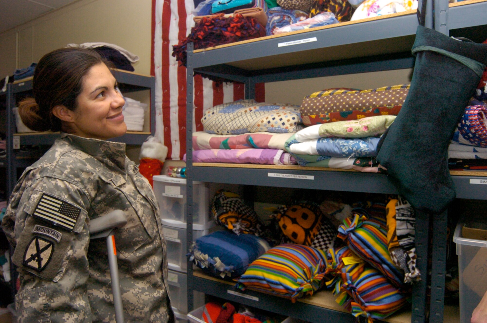 Specialist Marcela Supnet decides which quilt to select at the Wounded Warrior Ministry Center at Landstuhl Regional Medical Center in April 2008. The handmade quilts and other items are dispensed to Wounded Warriors and other patients at the hospital. The 99th Movement Control Team based at Aviano Air Base, Italy, recently raised nearly $8,000 worth of goods during their second annual Wounded Warrior Drive which will be donated to the LRMC. (U.S. Army Photo/Thomas Warner)