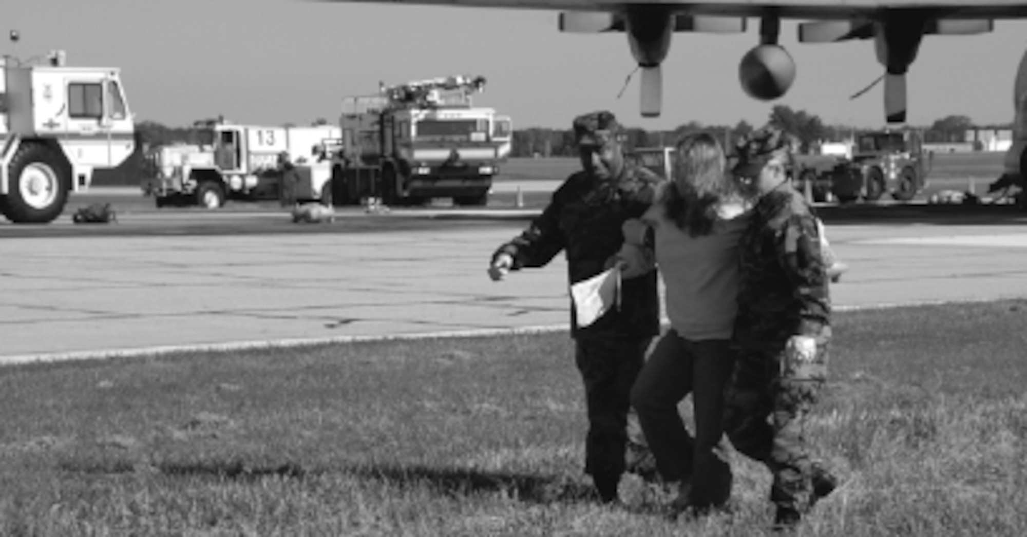 Schafer and Staff Sgt. Maurice Morrison, 182 Medical Group, assist volunteer patient Jennifer Omann, Pekin, to awaiting ambulances for transport to the hospital. Photo by Tech Sgt. Shane P. Hill