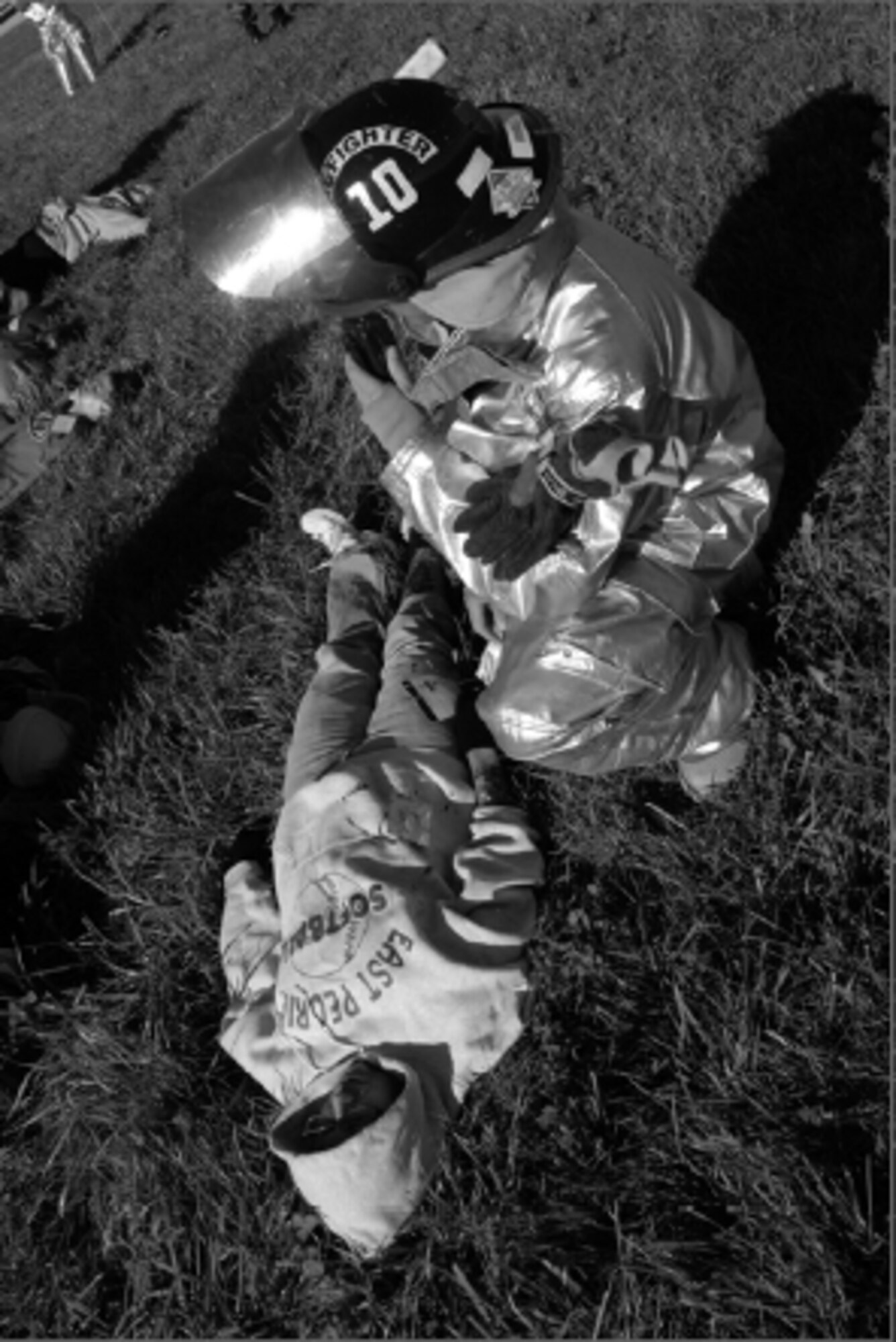 Staff Sgt. Shawn Penninger, 182nd Fire Department,triages mock accident victim WendySmoke, East Peoria. Smoke was playing the part of acritically injured patient breathing inadequately. Photo by Tech Sgt. Shane P. Hill