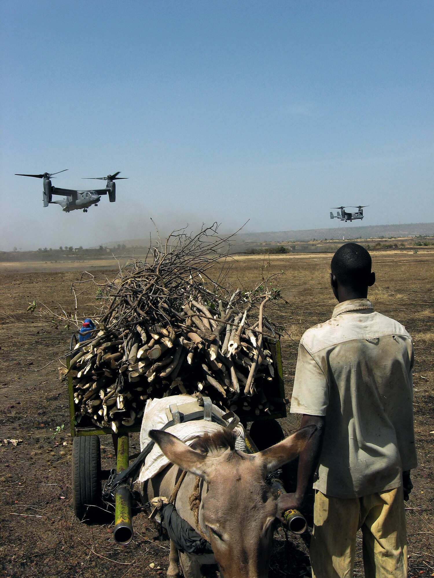 A Malian boy stops to watch incoming CV-22 Ospreys carrying Malian and Senegalese troops during an exercise near Bamako, Mali. U.S. Special Operations forces the worked with African and European partner nations in the effort to build bonds of trust and confidence. (U.S. Air Force photo/Capt. Bryan Purtell) 
