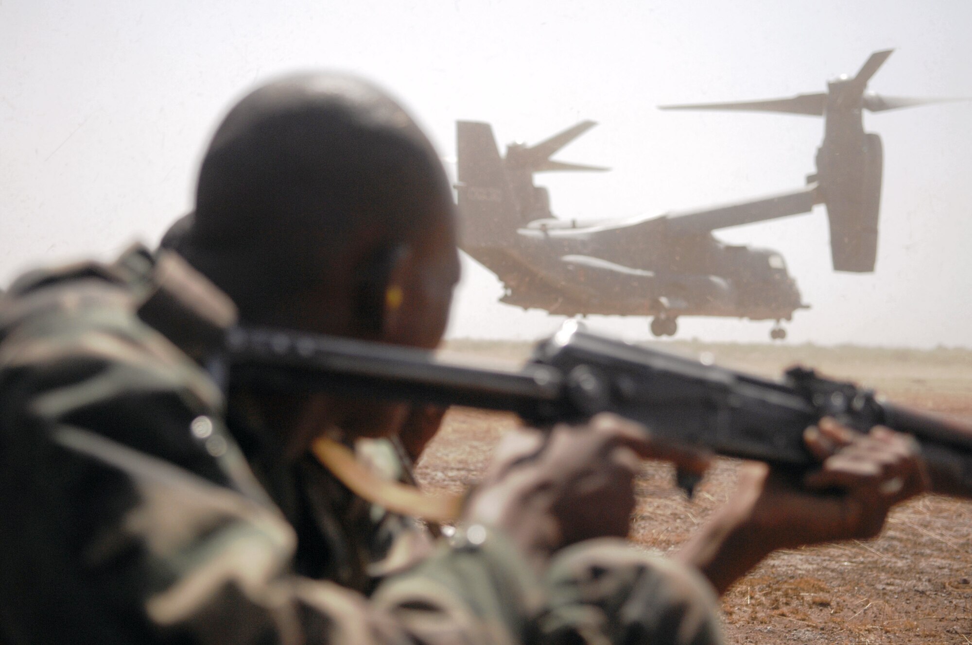 A Malian soldier takes a defensive position while an Air Force Special Operations Command CV-22 Osprey departs a landing zone as part of a drill for Exercise Flintlock in Bamako, Mali. (U.S. Air Force photo) 
