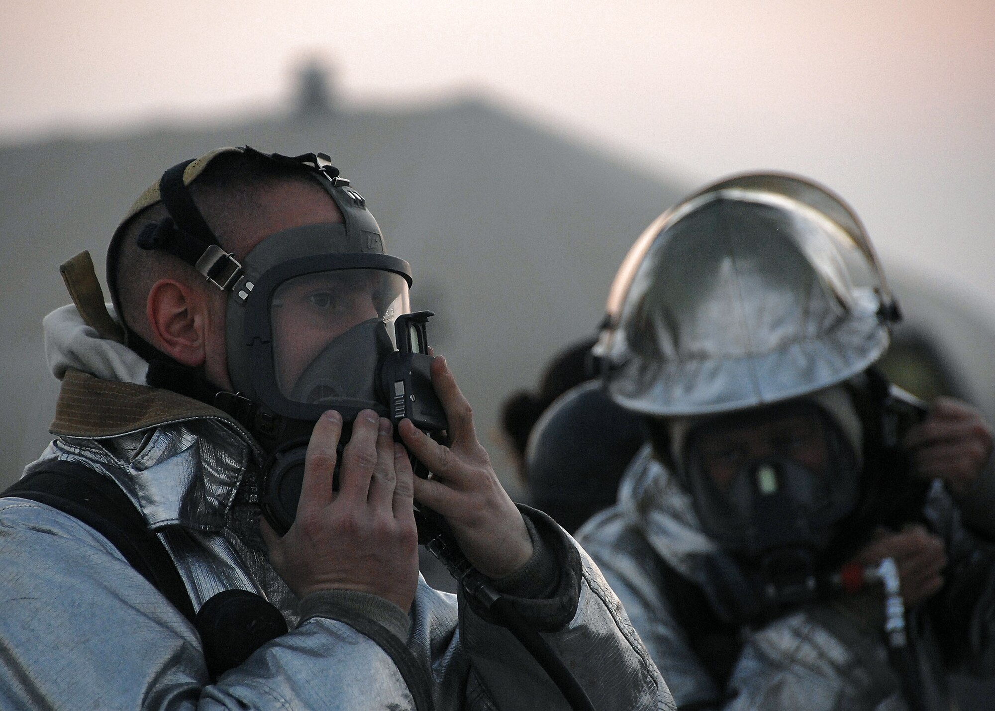 Firefighters from the 386th Expeditionary Civil Engineer Squadron check their gear prior to participating in a live fire aircraft trainer Nov. 24 at an air base in Southwest Asia. The firefighters must complete one daytime and nighttime live fire burn annually. (U.S. Air Force photo/Tech. Sgt. Raheem Moore) 

