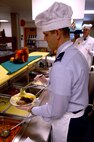 MINOT AIR FORCE BASE, N.D. -- Col. Steven Basham, 5th Bomb Wing vice commander, serves a plate of food during the Thanksgiving meal presented by the Dakota Inn Dining Facility and unit leaders here. Col. Basham was one of many leaders who showed their support for Minot's Airmen Nov. 27. (U.S. Air Force photo by Airman 1st Class Benjamin Stratton)