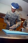 MINOT AIR FORCE BASE, N.D. -- Airman 1st Class Jabarie Borders, 5th Force Support Squadron food service apprentice, prepares turkey for the Thanksgiving meal presented by the Dakota Inn Dining Facility and unit leaders here. Turkey was just one of many treats served to Minot's Airmen Nov. 27. (U.S. Air Force photo by Airman 1st Class Benjamin Stratton)