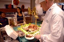 MINOT AIR FORCE BASE, N.D. -- Col. Joel Westa, 5th Bomb Wing commander, serves Tech. Sgt. Linda Miller, 5th Bomb Wing assistant base visual information manager, a piece of prime rib during the Thanksgiving meal presented by the Dakota Inn Dining Facility and unit leaders here. Prime rib was just one of many treats served to Minot's Airmen Nov. 27. (U.S. Air Force photo by Airman 1st Class Benjamin Stratton)