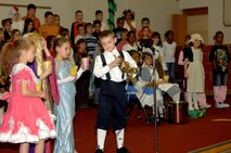 MINOT AIR FORCE BASE, N.D. -- Shane Young, son of Lt. Col. David Young, 91st Missile Security Forces Squadron, prepares to play his bugle as others in the performance look on. Darcy Klingbeil, North Plains Elementary School music teacher, brought kids together from the 3rd and 4th grades in a musical entitled, "Lemonade." The musical combined many nursery rhyme stories into one performance held recently here. (U.S. Air Force photo by Airman 1st Class Benjamin Stratton)