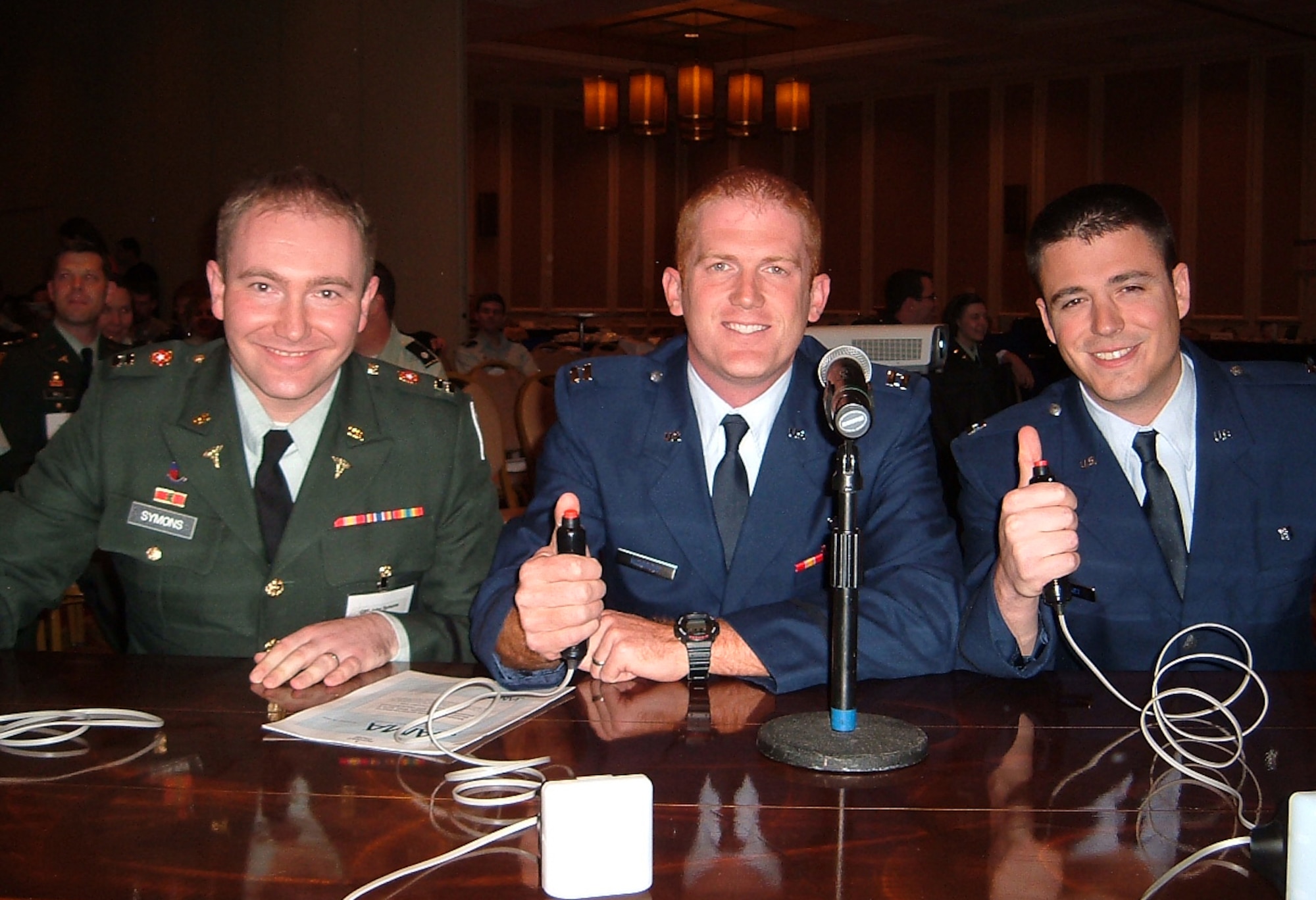 Capt. (Dr.) John Symons, Capt. (Dr.) Ben Morrow, and Capt. (Dr.) Ian Stewart prepare to buzz in their answers during the Jeopardy/Challenge Bowl on Nov. 21.  Dr. Symons, an Army internal medicine resident, and his Air Force teammates won first place during the Air Force competition which was part of the Army/Air Force American College of Physicians annual meeting.  (U.S. Photo by Capt. Eric Flynt)