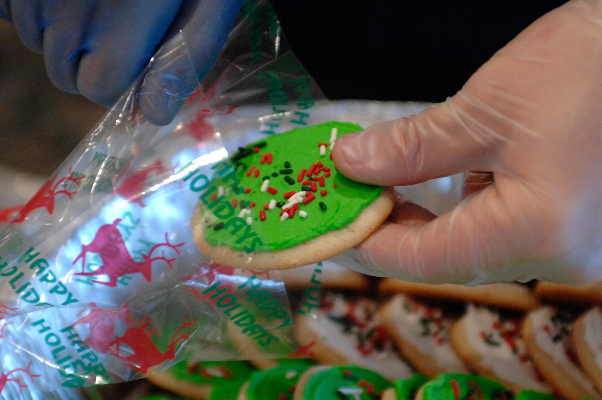 Tony Sullivan bags cookies during the Airman Cookie Drive at the La Bella Vista club Dec. 2.  Volunteers from across the Aviano community pitched in to help bake, package and deliver more than 9,200 cookies to Airmen living on base.  (U.S. Air Force photo/Airman 1st Class Ashley Wood)