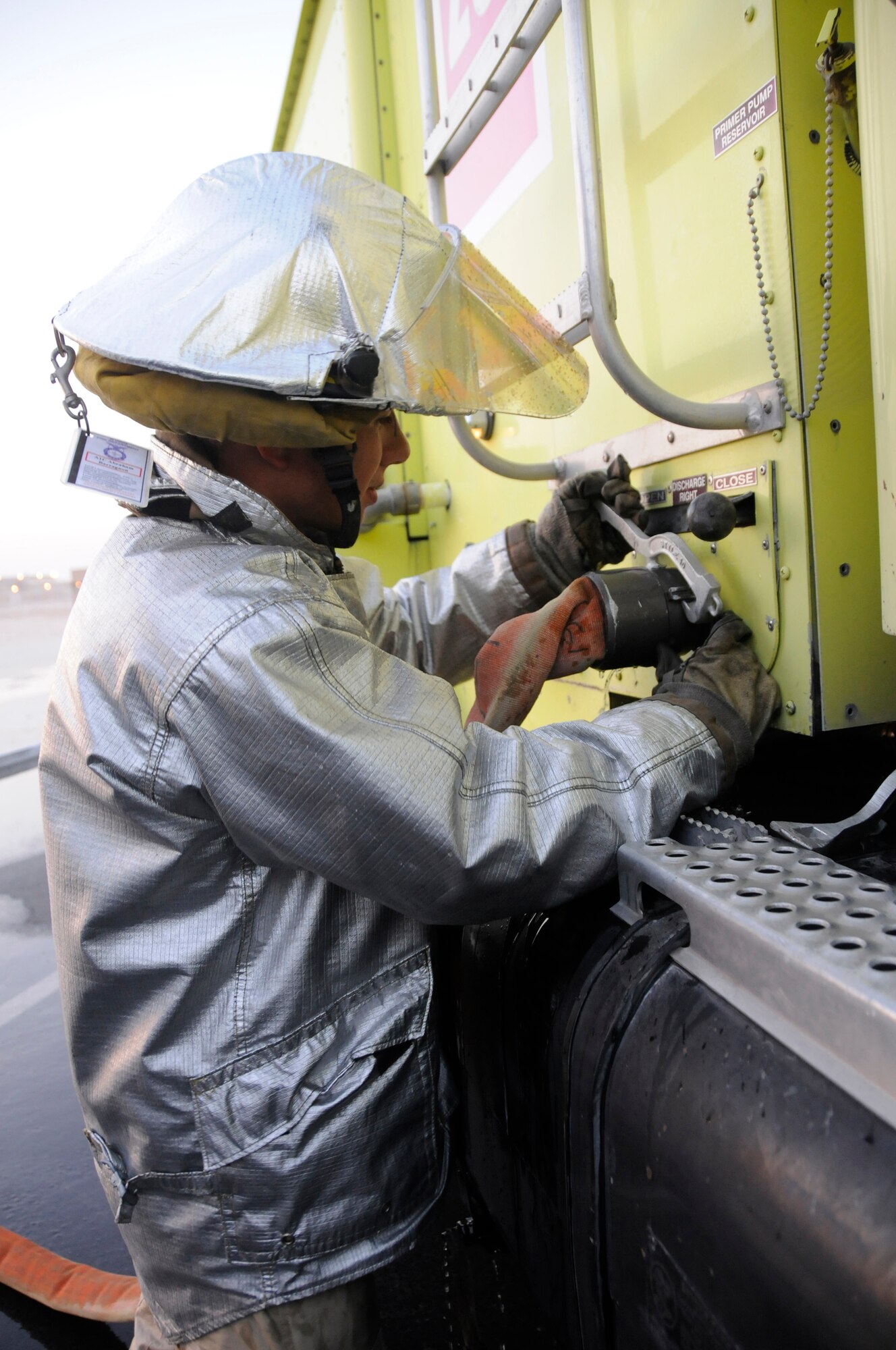 Airman 1st Class Abe Barragnon, a firefighter assigned to the 379th Expeditionary Civil Engineer Squadron, uses a clamp to disconnect the fire hose from the fire engine during a fire training exercise Dec. 1, at an undisclosed air base in Southwest Asia. Firefighters here train daily to ensure they are prepared should disaster strike.  Airman Barragnon, a native of Los Angeles, Calif., is deployed from Travis Air Force Base, Calif., in support of Operations Iraqi and Enduring Freedom and Joint Task Force-Horn of Africa. (U.S. Air Force photo by Staff Sgt. Darnell T. Cannady/Released)