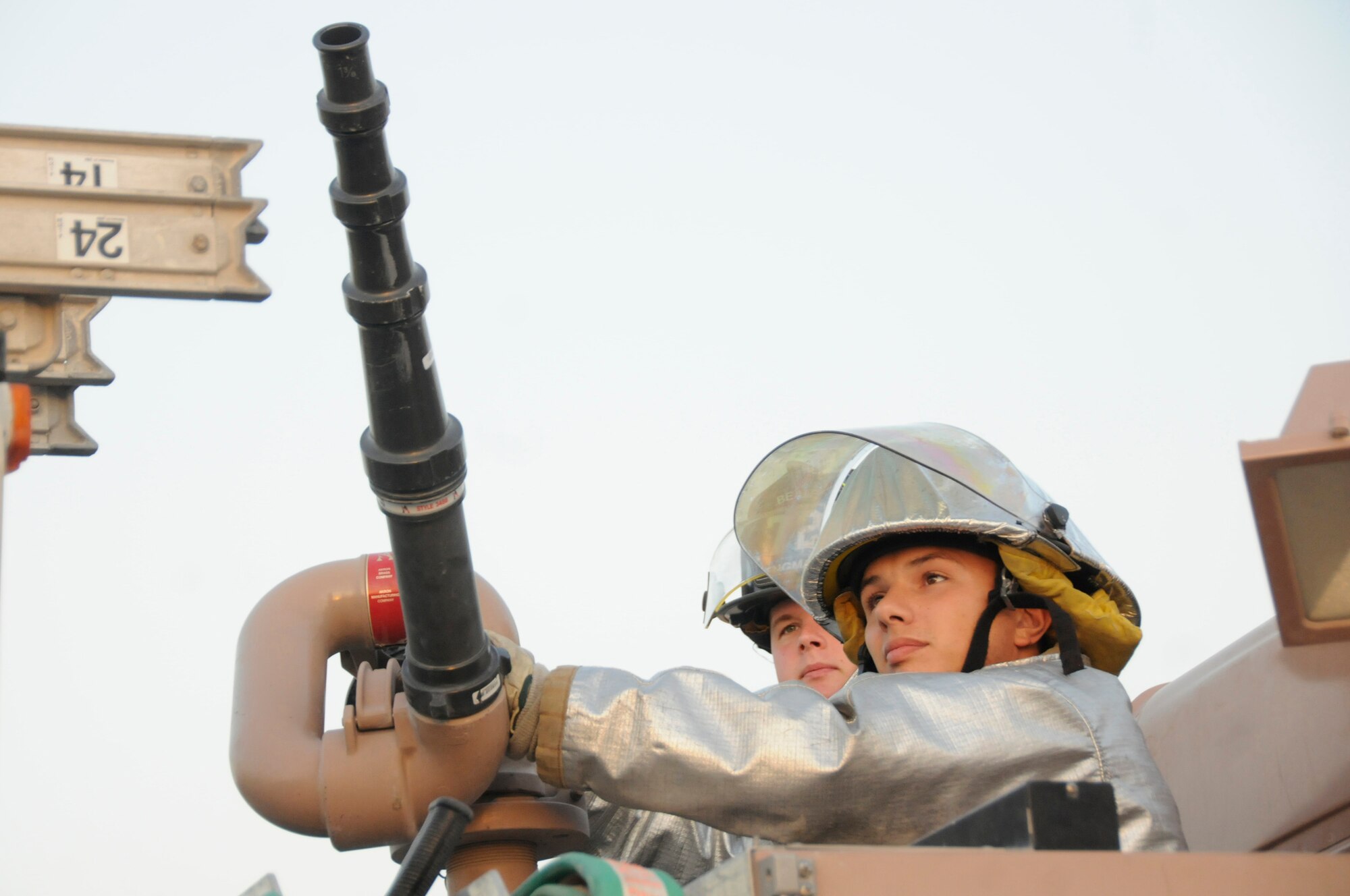 Senior Airman Chad Engman and Airman 1st Class Abe Barragnon, firefighters assigned to the 379th Expeditionary Civil Engineer Squadron, prepare to fire a water cannon Dec. 1, at an undisclosed air base in Southwest Asia. The water cannon at full power will empty its water tank in one minute. A daisy chain approach is used from a fire hydrant to a filler truck and finally into the truck which will fight the fire. Airman Engman, a native of Cincinnati, Ohio, is deployed from Beale Air Force Base, Calif. Airman Barragnon hails from Los Angeles, Calif., and is deployed from Travis AFB, Calif. Both are deployed in support of Operations Iraqi and Enduring Freedom and Joint Task Force-Horn of Africa