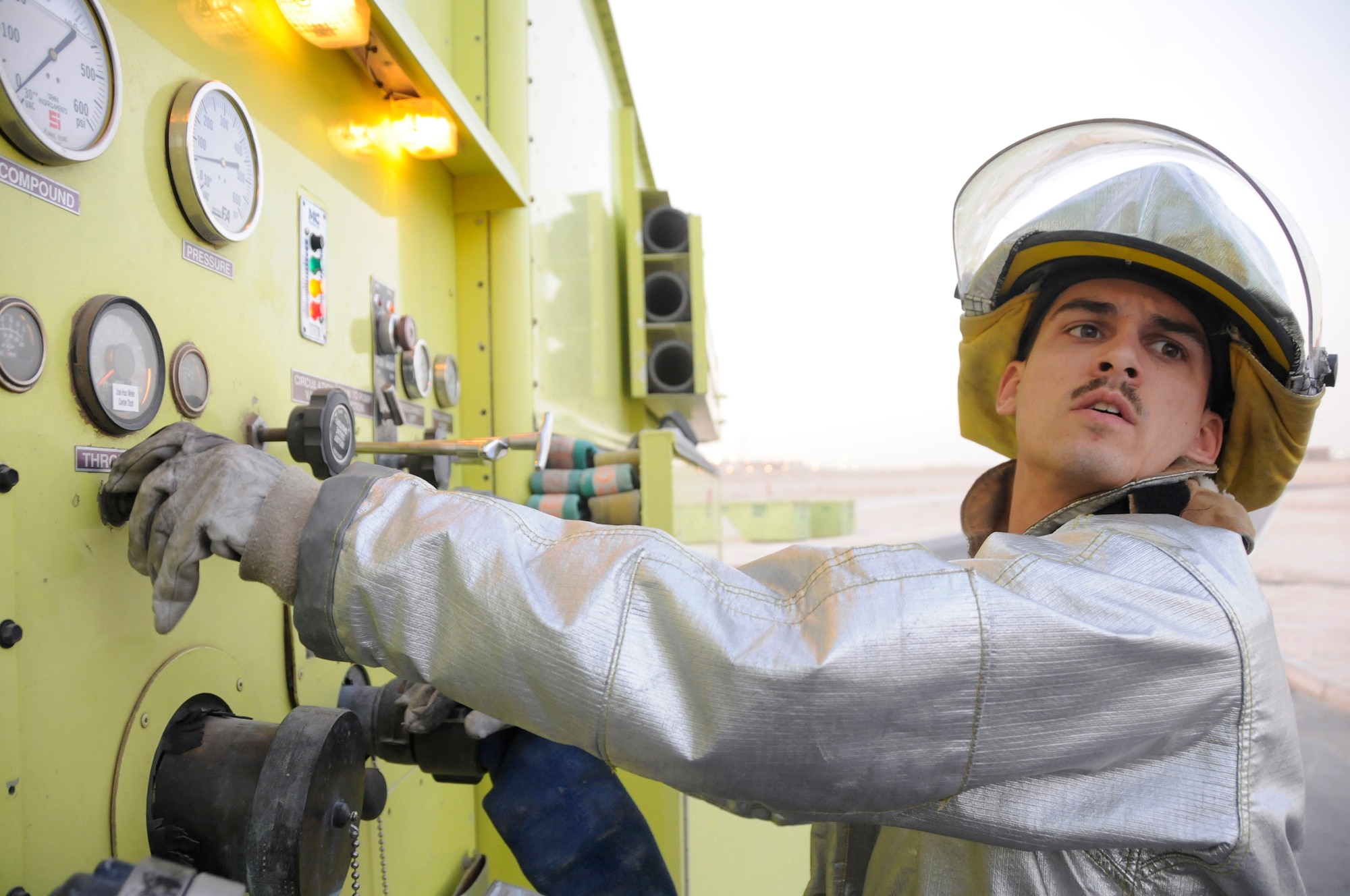 Airman 1st Class Cory Pitrat, a firefighter assigned to the 379th Expeditionary Civil Engineer Squadron, monitors water pressure during water resupply Dec. 1, at an undisclosed air base in Southwest Asia. Firefighters here train daily to ensure they are prepared should disaster strike.  Airman Pitrat, a native of Phoenix, Ariz., is deployed from Davis-Monthan Air Force Base, Ariz., in support of Operations Iraqi and Enduring Freedom and Joint Task Force-Horn of Africa. (U.S. Air Force photo by Staff Sgt. Darnell T. Cannady/Released)