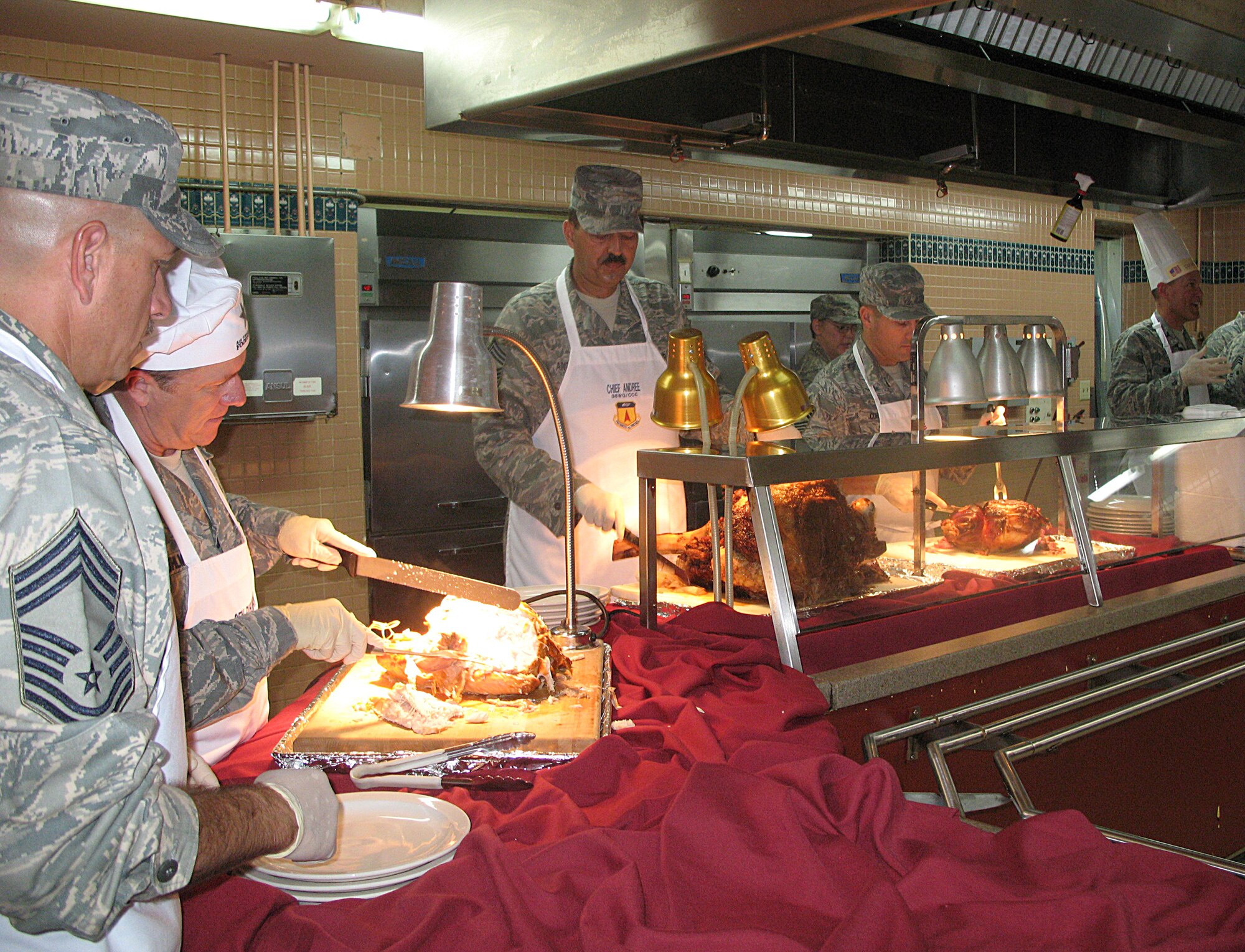 ANDERSEN AIR FORCE BASE, Guam -- Team Andersen leadership serve Airmen at the Madgellan Inn Nov. 27 here. The leadership of the base serving Thanksgiving dinner to Airmen of Andersen has been a tradition upheld at Andersen for several years. (U.S. Air Force photo by Airman 1st Class Carissa Wolff)