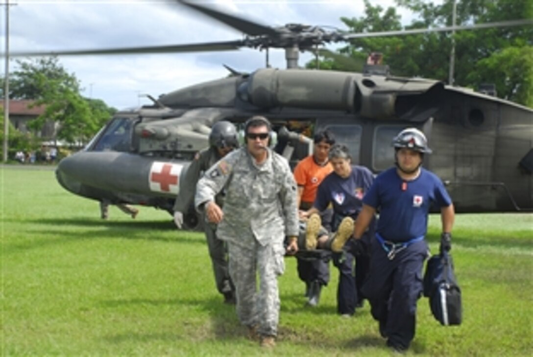 U.S. Army Staff Sgt. Jose Gutierrez and Spc. Robert Hunt carry an injured man from a medivac helicopter Dec. 1, 2008. More than 60 Joint Task Force-Bravo personnel helped provide humanitarian flood relief missions in Costa Rica and Panama.