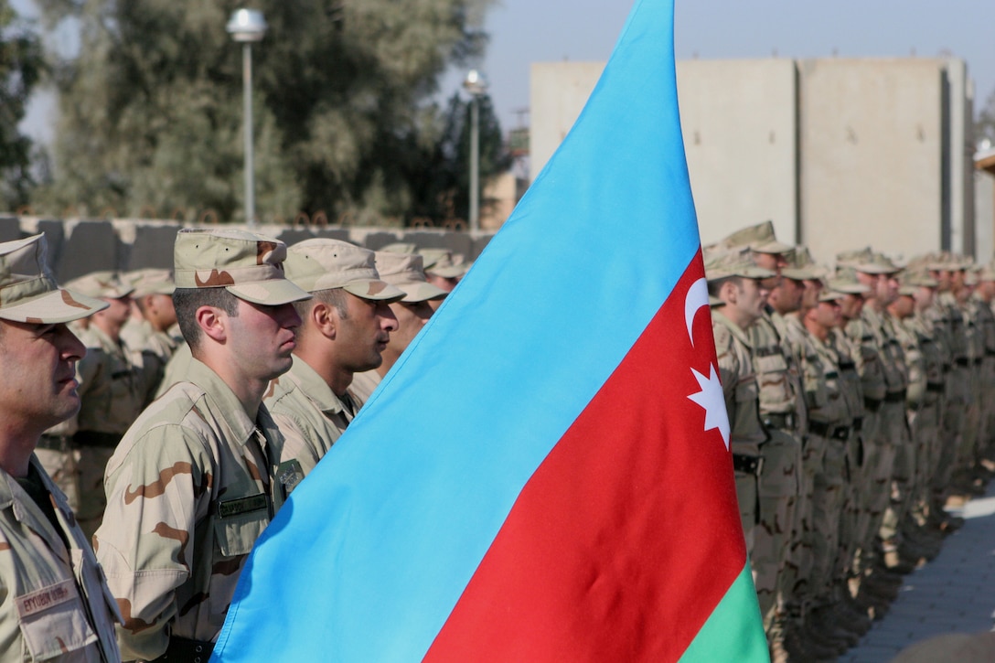 Soldiers with the 1st Azerbaijani Peacekeeping Company stand in formation during a ceremony at Camp Ripper, Al Asad Airbase, Iraq, Dec. 3.  During the ceremony, Coalition forces recognized the hard work and dedication that Azerbaijani soldiers have contributed while serving in Iraq.  For the past five years, Azerbaijani soldiers have provided security at the Haditha Dam, which produces over 25 percent of Iraqâ??s electrical power.  Iraqi Security Forces will now provide security at the dam, and the Azerbaijanis will soon return home.::r::::n::