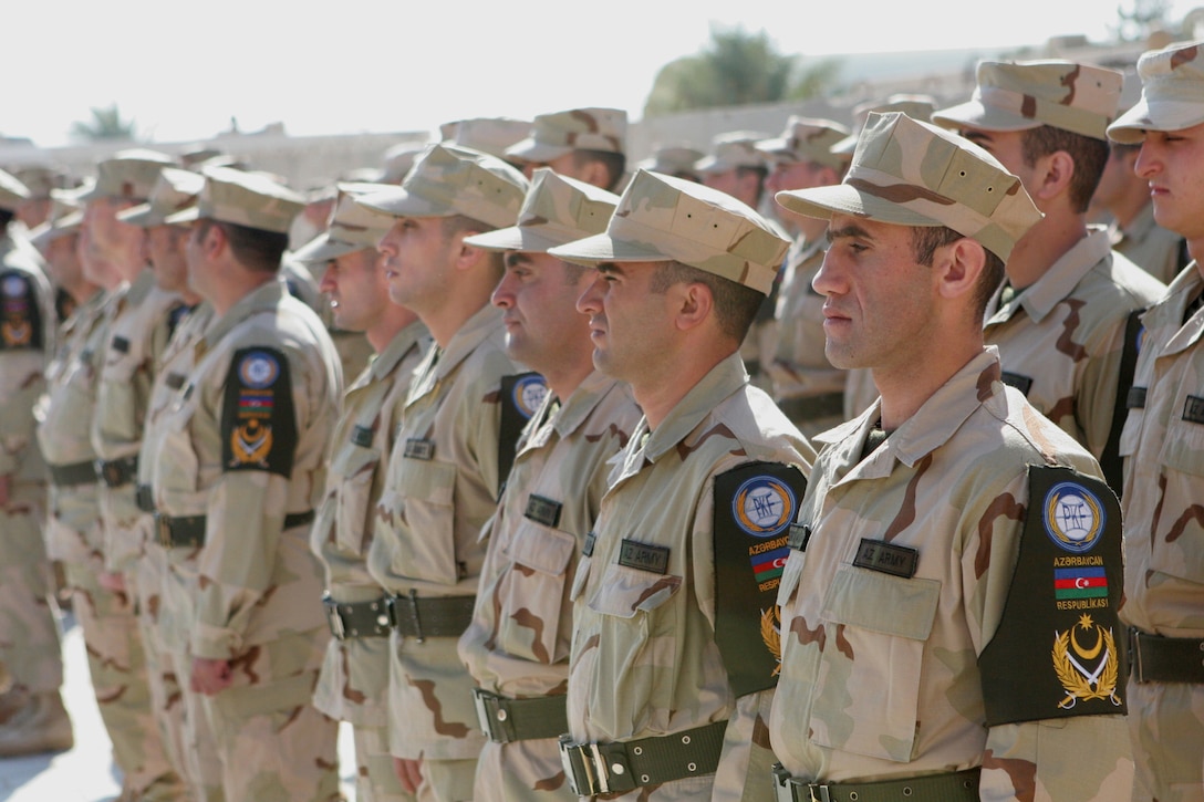 Soldiers with the 1st Azerbaijani Peacekeeping Company stand in formation during a ceremony at Camp Ripper, Al Asad Airbase, Iraq, Dec. 3.  During the ceremony, Coalition forces recognized the hard work and dedication that the Azerbaijani soldiers have done while serving in Iraq.  For the past five years, Azerbaijani soldiers have provided security at the Haditha Dam, which produces over 25 percent of Iraqâ??s electrical power.  Iraqi Security Forces will now provide security at the dam, and the Azerbaijanis will soon return home.::r::::n::