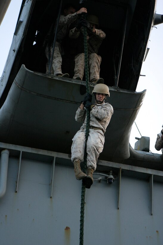 A Marine with the 26th Marine Expeditionary Unit fast-ropes off the back of a CH-46E Sea Knight helicopter aboard USS Iwo Jima, Dec. 4, 2008. Reconnaissance Marines with the MEU's Command Element conducted the sustainment training and invited other CE sections to participate to maintain their own proficiency. The 26th MEU and Iwo Jima Strike Group are currently deployed to the 5th Fleet area of operation.