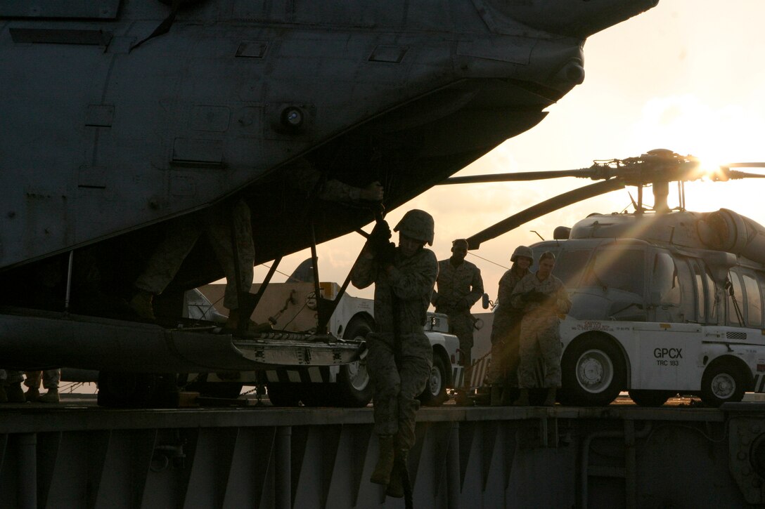A Marine with the 26th Marine Expeditionary Unit fast-ropes off the back of a CH-46E Sea Knight helicopter aboard USS Iwo Jima, Dec. 04, 2008. Reconnaissance Marines with the MEU's Command Element conducted the sustainment training and invited other CE sections to participate to maintain their own proficiency. The 26th MEU and Iwo Jima Strike Group are currently deployed to the 5th Fleet area of operation.