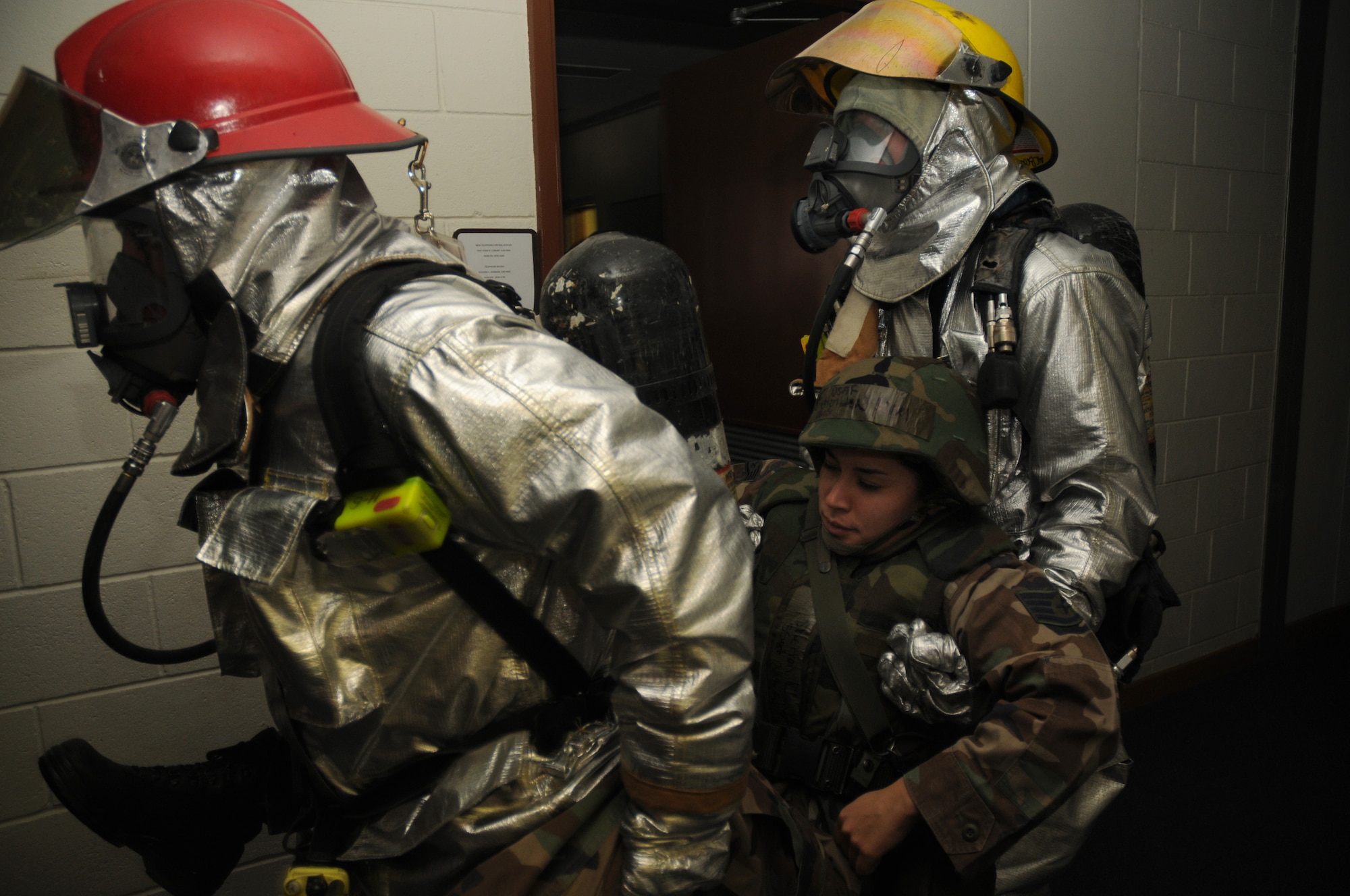 Kadena fire fighters remove an injured person from a building following a simulated missile strike at Kadena Air Base, Japan Dec. 03, 2008. The simulation is part of a Local Operational Readiness Exercise meant to test the operational readiness of Kadena Airmen. (U.S. Air Force photo/Airman 1st Class Chad Warren)