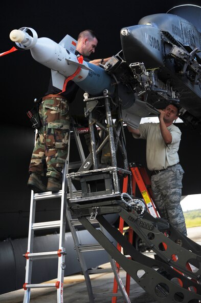 (left) Tech. Sgt Jamie Mikus locks an inert GBU-31 in place onto a B-52 Stratofortress while Staff Sgt. Richard Timmerman guides it in Nov. 26, at Andersen Air force Base, Guam during the Aces North exercise. Aces North is a two week mission employment phase of the Australians version of the U.S. Air Force Weapons School.  The exercise is scheduled to end Dec. 4. Both are 23rd Expeditionary Bomb Squadron weapons loaders deployed from Minot Air Force Base, N.D. The bomber's participation in constant training helps emphasize the U.S. bomber presence, demonstrating U.S. commitment to the Pacific region.


(U.S. Air Force photo/ Master Sgt. Kevin J. Gruenwald) released




















  












 


























