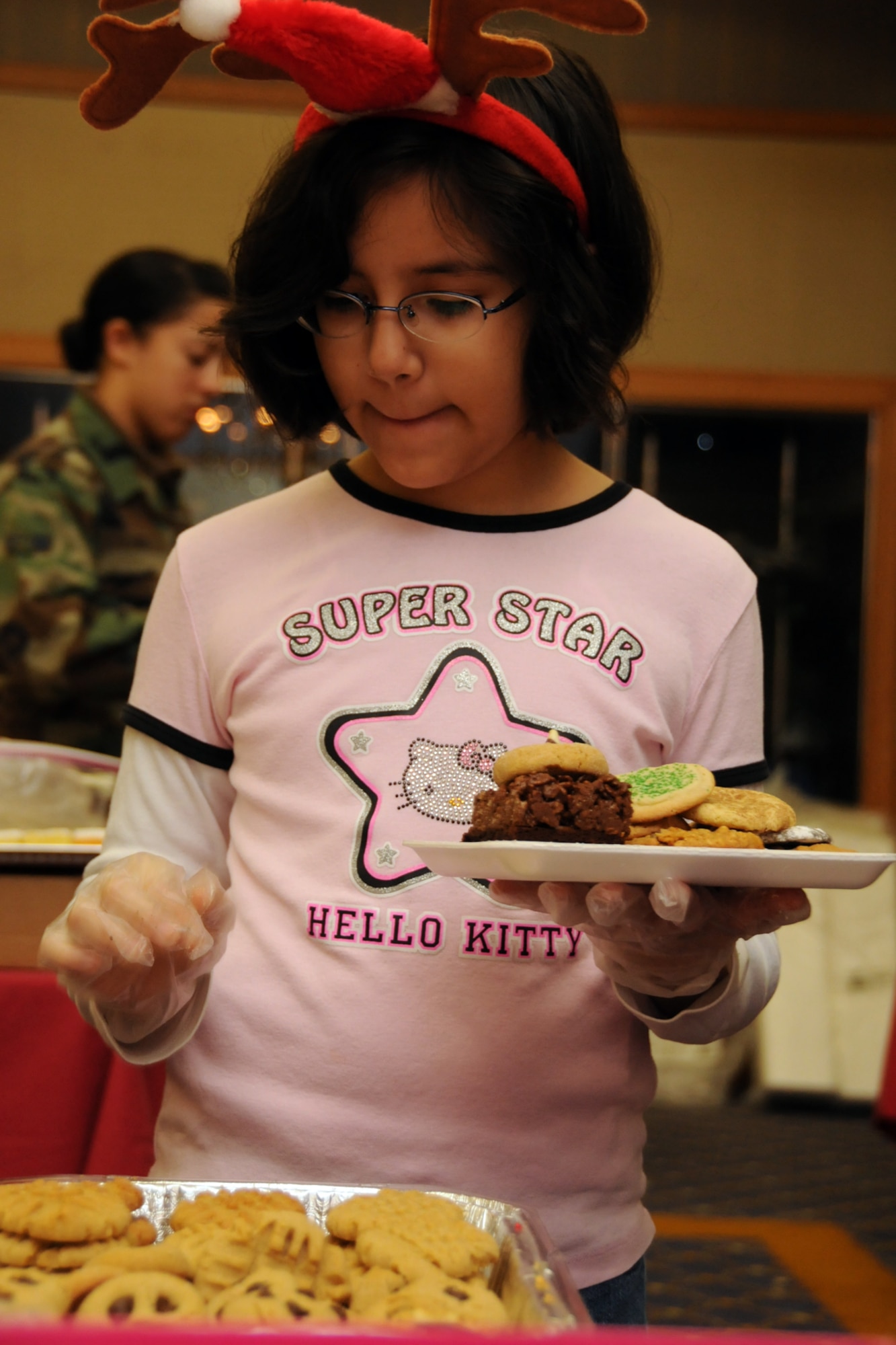 MISAWA AIR BASE, Japan -- Marissa Gonzalez, daughter of Senior Master Sgt. Evangeline Gonzalez, 35th Logistics Readiness Squadron, ponders her choice of cookies during the 35th Figher Wing Cookie Caper Dec. 3, 2008. This is Marissa's fifth year volunteering to help with the cookie drive. (U.S. Air Force photo by Senior Airman Jamal D. Sutter)
