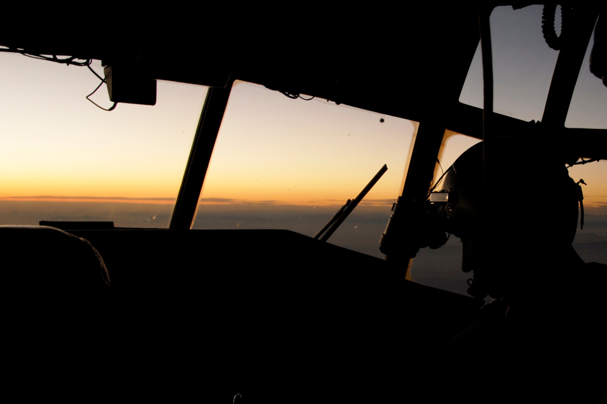 Co-Pilot Lt. Jason Christensen, prepares night vision goggles before landing at Camp Bastian, Kandahar Airfield, southern Afghanistan to transport nearly 50 Marines to Bagram, Airbase so they can return home Monday, Dec. 1, 2008. 