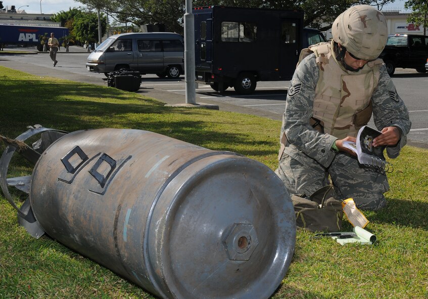 An 18th Wing EOD Technician identifies an unexploded ordnance outside Chapel 2 at Kadena Air Base, Japan during a Local Operational Readiness Exercise Dec. 04, 2008. These simulations are meant to test the operational readiness of Kadena Airmen. (U.S. Air Force photo/Airman 1st Class Chad Warren)