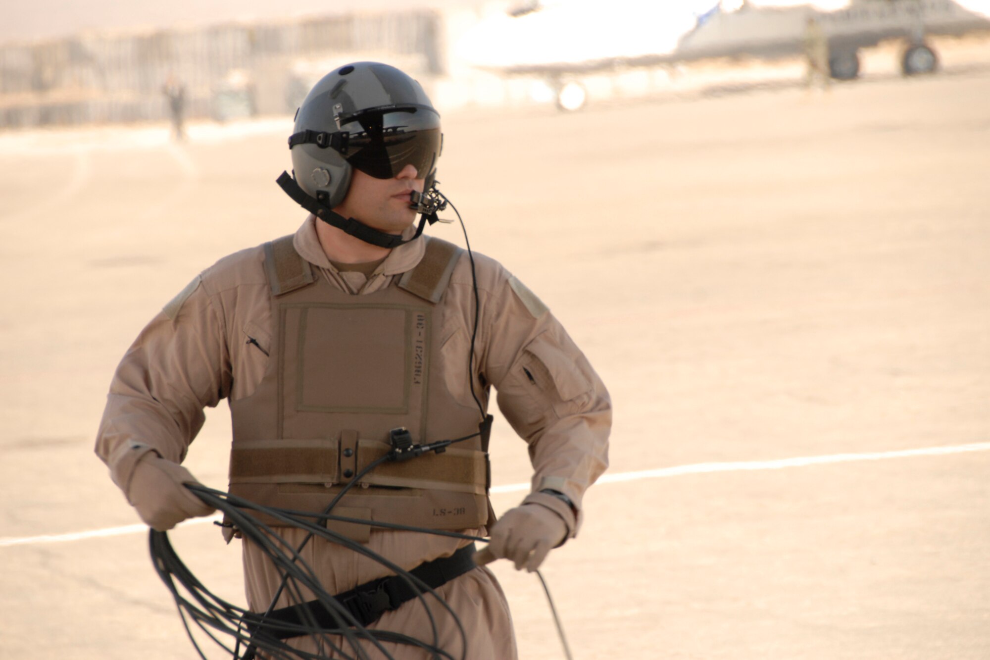 Master Sgt. Josh Meister, Loadmaster with the 109th Airlift Squadron, 133rd Airlift Wing, stands on the ground near the rear of the aircraft to guide C-130 Hercules pilots into position at a military airbase in Herat, Afghanistan Monday, Dec. 1, 2008.  