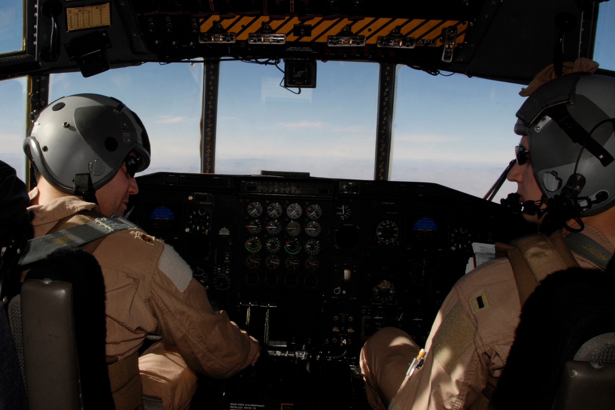 Command Pilot, Maj. Jeff Wong (left) and Co-Pilot, 1st Lt. Jason Christensen (right), with the 109th Airlift Squadron, 133rd Airlift Wing, fly a C-130 Hercules aircraft on their first mission in country to transport top U.S. Army and Afghan military leaders from a military airbase in Herat, Afghanistan to Kabul on Monday, Dec. 1, 2008.