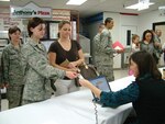 11/27/2008 - Penny Lindley accompanies Air Force trainee Danielle Gates as Cecilia Staggs out-processes her from the Basic Military Training Visitor's Center during Operation Homecooking. (USAF photo by Joe Bela)
