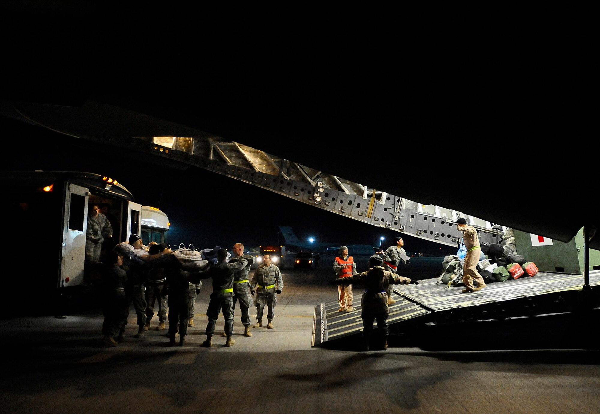 Airmen carefully lower a patient from an ambulance Nov. 27 at Joint Base Balad, Iraq. Patients are loaded onto aircraft before being aeromedically evacuated out of Iraq. In 2008, more than 7,500 patients have been transported from the contingency aeromedical staging facility in 650 missions. (U.S. Air Force photo/Airman 1st Class Jason Epley)