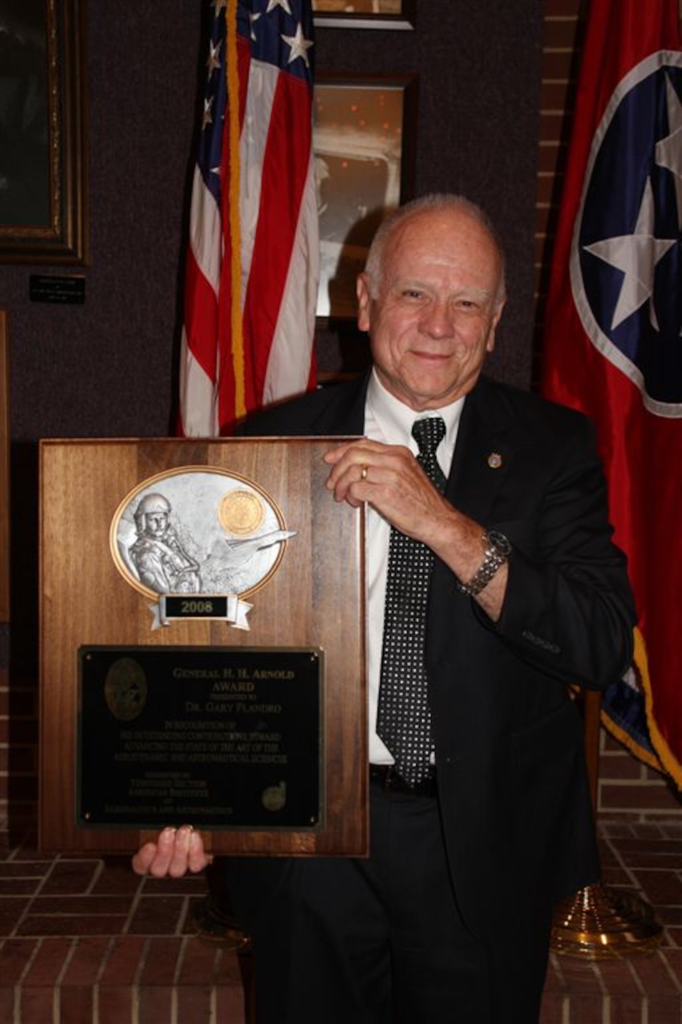 Prof. Gary Flandro of the University of Tennessee Space Institute holds up his General Henry H. H. Arnold Award. (Photo provided)