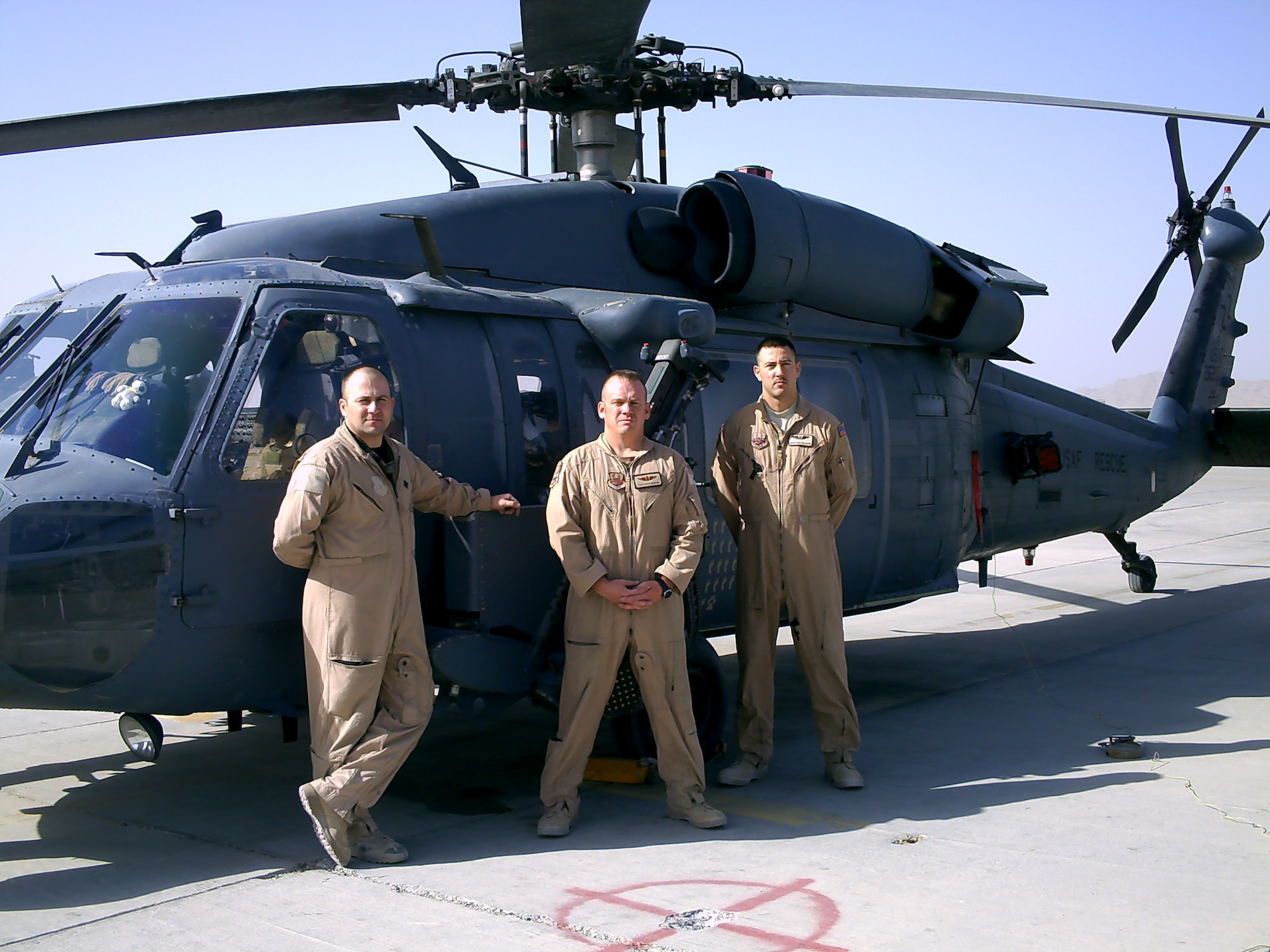 Tech. Sgt. David Denton (center), 375th Aeromedical Evacuation squadron senior flight medic, poses in front of their HH-60 Pavehawk with fellow medics, Tech. Sgt. David Thackery (left) and Staff Sgt. Nicholas Falcon, both from the 43rd Aeromedical Evacuation Squadron at Pope Air Force Base, N.C.
(Courtesy photo)