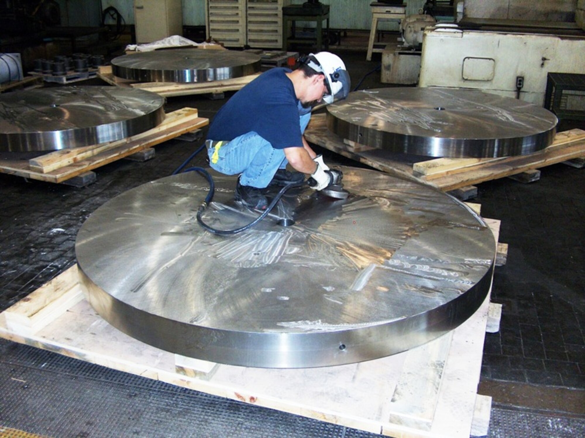 Teddy Perry, an outside machinist with ATA’s test and facilities support branch, removes imperfections from the surface of an 8,000 pound weight to be used for an Ormond Calibration System at the Army’s Redstone Arsenal in Huntsville, Ala. (Photo by James Winchester)