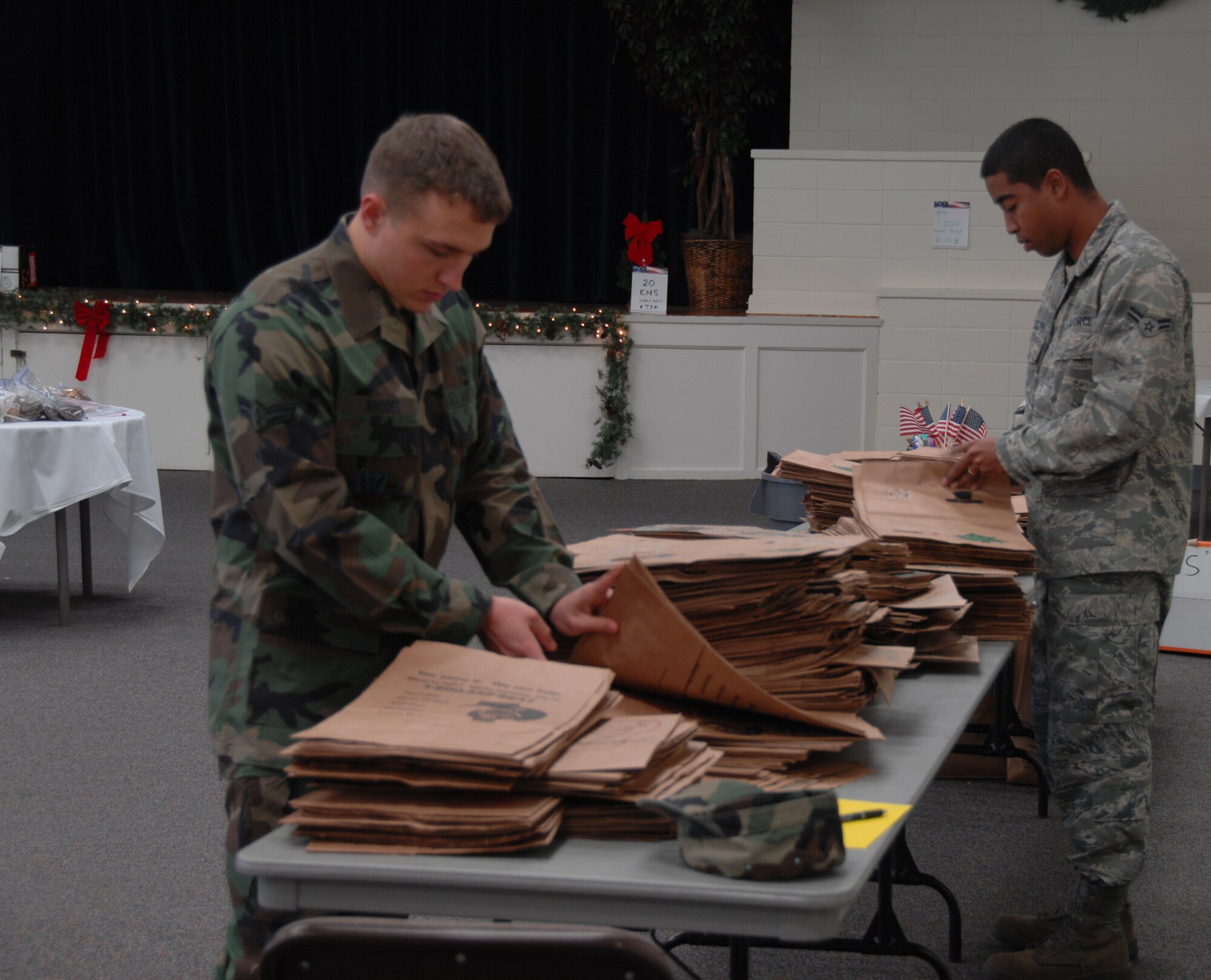SHAW AIR FORCE BASE, S.C. -- Volunteers prepare brown paper bags to be filled with cookies at this year's Annual Cookie Drive. The brown bags were donated by the Shaw AFB Commissary and decorated by children from local schools and churches. (U.S. Air Force photo/2nd Lt. Emily Chilson)