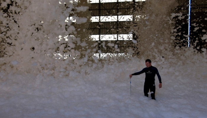 1st Lt. Joshua Brock measures the height of the fire retardant foam in a hangar on Charleston AFB Dec. 3. Base officials tested the newly installed system and will continue to test it every five years to ensure the proper amount of foam is released within a certain time period. Lieutenant Brock is with the 437th Contracting Squadron. (U.S. Air Force photo/Senior Airman Timothy Taylor)