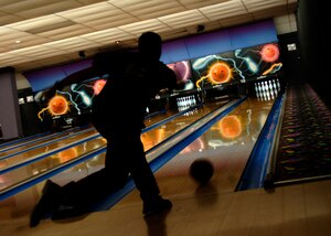 Zachary Chappell throws his first hook ball of the night during intramural bowling at Starlifter Lanes Dec. 3. There are 12 teams that will be competing until the season ends in April. Chappell is with the 437th Operations Support Squadron. (U.S. Air Force photo/Senior Airman Timothy Taylor)