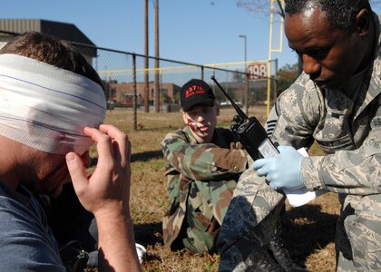 Master Sgt. Kenneth Friday takes care of Staff Sgt. Brandon Bennett during an exercise on Charleston AFB Dec. 2. The base conducted the exercise to test how Airmen respond to a simulated explosion caused by an improvised explosive device. Sergeants Friday is with the 437th Medical Group and Sergeant Bennett is with the 437th Medical Operations Squadron. (U.S. Air Force photo/Airman 1st Class Katie Gieratz)
