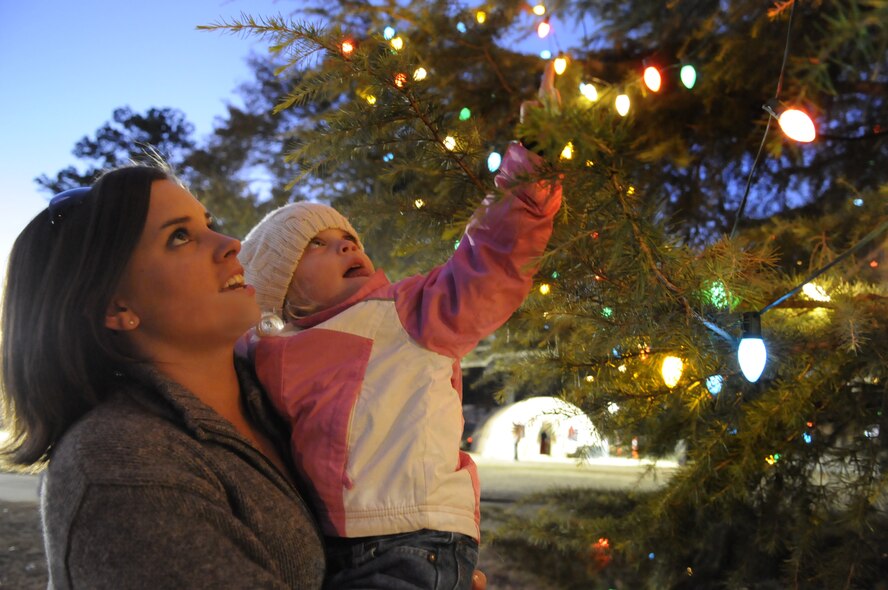 Brandy Henderson and her daughter Madilyn, 3, take a look at the lights on the Robins Chapel Christmas tree after the tree lighting service Dec. 3. Robins Elementary Chorus provided music and Santa Claus arrived in a fire truck to hand out candy canes to the children. U. S. Air Force photo by Sue Sapp