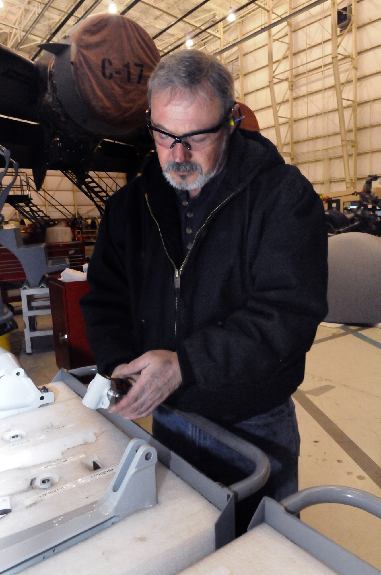 Dwayne Markham, aircraft hydraulics, works on a NLG (nose landing gear actuator for a C-17 Dec. 2. U. S. Air Force photo by Sue Sapp