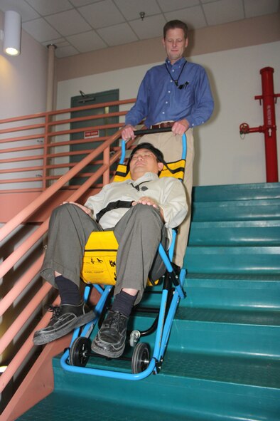 Jack Brannen, trained Mk3 EVAC-CHAIR operator, and Vu Le, simulated mobility challenged person, demonstrate the use of the device in descent mode. courtesy photo