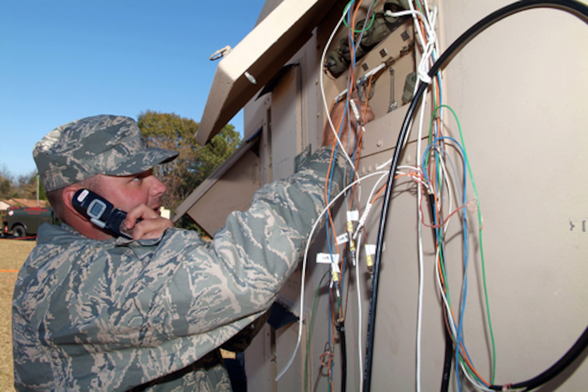 Staff Sgt. Trent Lundell, 54th Combat Communications Squadron, attaches a fiber optics connection to the TRC-170 access panel to configure a loopback connectivity test to the distant end.  U.S. Air Force photos by Tommie Horton
