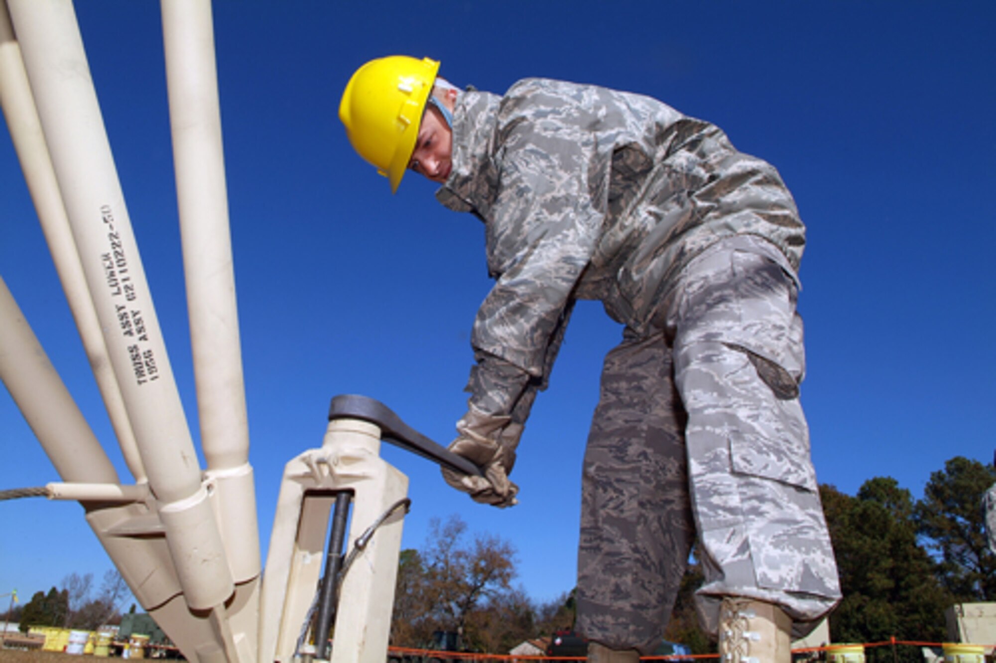 Airman 1st Class David Huntsberger tightens the anchors for the antenna of the  AN/TRC-170, a Tropospheric Scatter Microwave Radio Terminal. U.S. Air Force photos by Tommie Horton