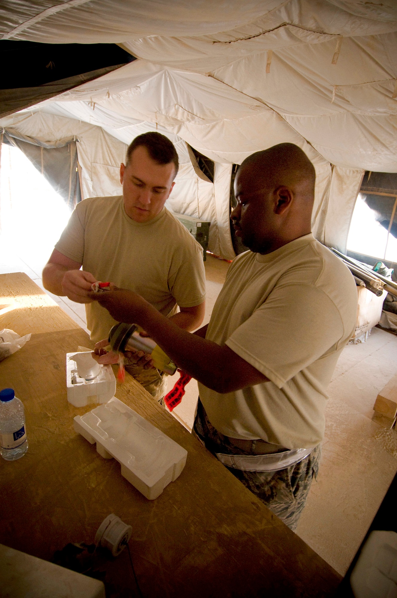 Staff Sgt. Jared Wood and Master Sgt. James Bradley inspect joint programmable fuzes Oct. 27 at Kandahar Airfield, Afghanistan. Part of their role is to perform operation and function checks to ensure bombs and missiles will detonate when they are supposed to. They are assigned to the 451st Air Expeditionary Group Logistics Flight-Ammo. Sergeant Wood is deployed from Langley Air Force Base, Va., and Sergeant Bradley is deployed from Minot AFB, N.D. (U.S. Air Force photo/Staff Sgt. Samuel Morse) 
